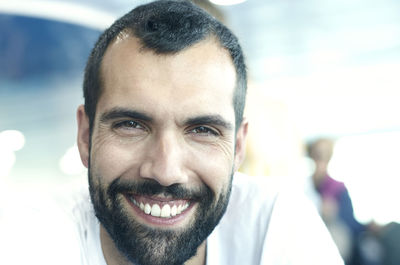 Close-up portrait of smiling bearded man