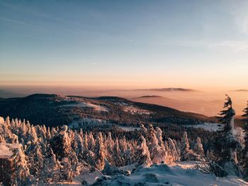 Scenic view of snow covered mountains against sky
