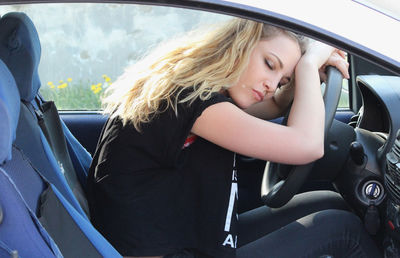 Portrait of woman sitting in car