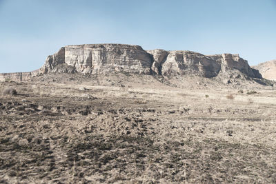 Rock formations in desert against sky