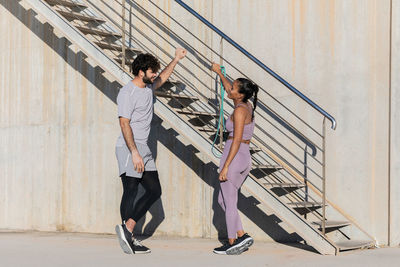 Side view of young couple standing on staircase