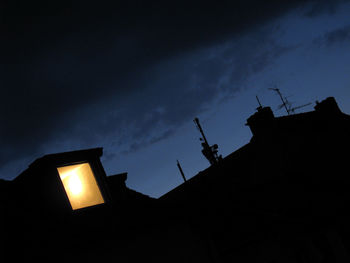 Low angle view of illuminated building against sky at night