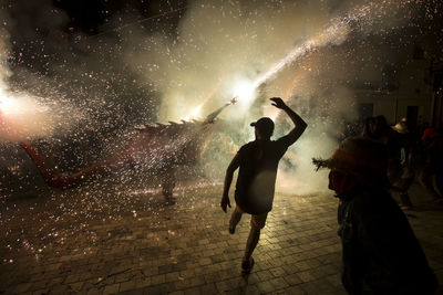 Man at enjoying fireworks at night