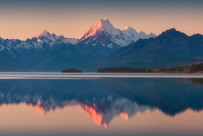 Scenic view of snowcapped mountains against sky during sunset