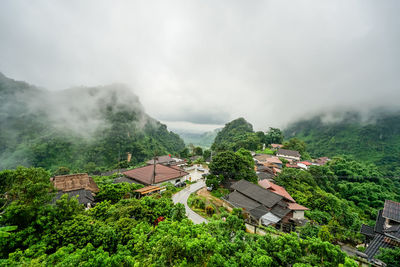 High angle view of houses and trees against sky