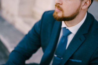 Portrait of man standing against building