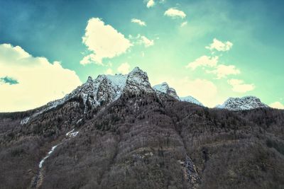 Low angle view of rock formation against sky