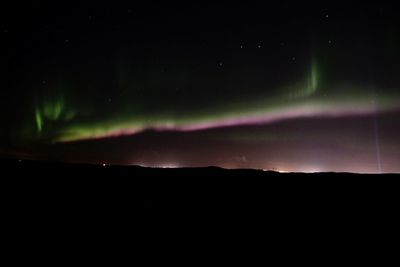 Scenic view of silhouette mountain against sky at night