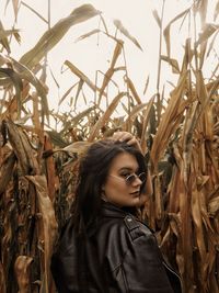 Portrait of young woman standing in farm