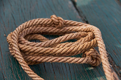 Close-up of rope on wooden plank