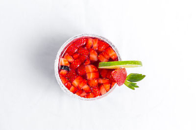 High angle view of fruits in bowl against white background