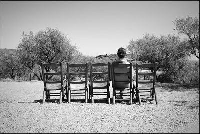 Rear view of man sitting on chair