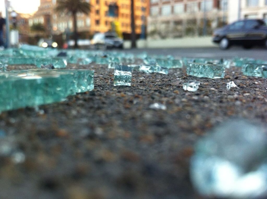 surface level, selective focus, focus on foreground, water, close-up, wet, street, day, outdoors, beach, nature, no people, drop, road, sand, transparent, season, empty, sunlight, asphalt