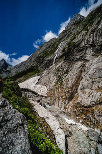 Low angle view of mountain against blue sky