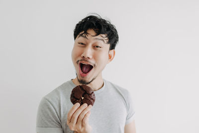 Portrait of mid adult man against white background