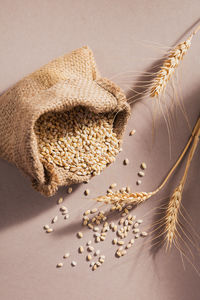 Burlap bag of dry raw broken pearl barley cereal grain