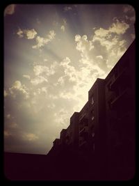 Low angle view of buildings against sky at sunset