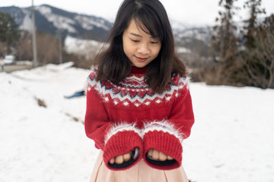 Smiling woman standing in snow