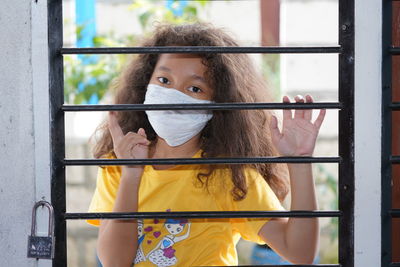 Portrait of woman standing by window