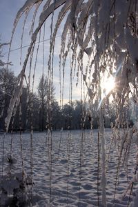 Frozen lake against sky during winter