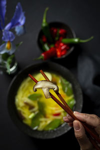 Cropped hand of person eating food at table