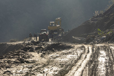 Worker and construction vehicle at mining site