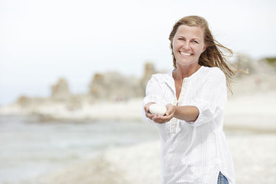 Smiling woman holding stone