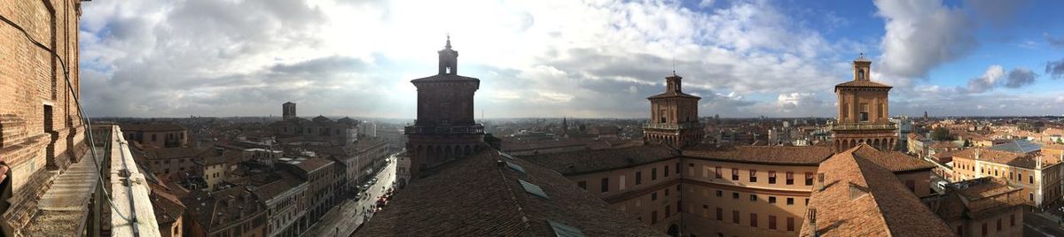 Panoramic view of buildings in city against sky