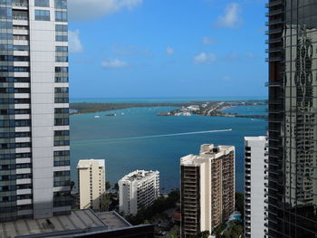 High angle view of buildings by sea against sky