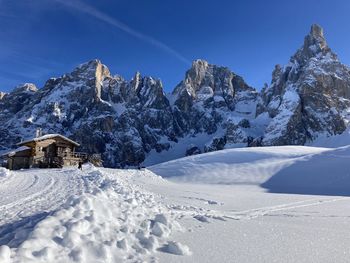 Scenic view of snowcapped mountains against blue sky