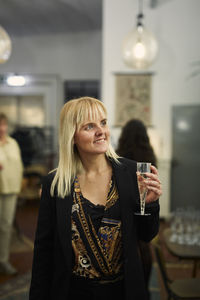 Woman with champagne glass during meeting in cafe