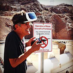Side view of man photographing with text