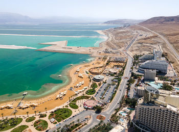 High angle view of sea and cityscape against sky