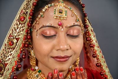 Close-up of beautiful young bride with eyes closed at home