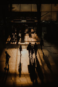 Group of people walking on tiled floor in city
