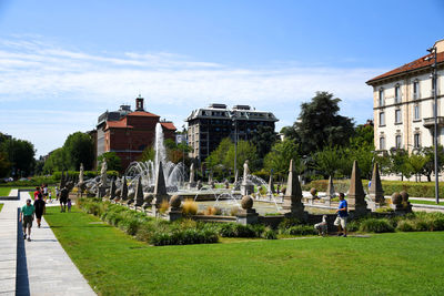 View of fountain in park against buildings in city