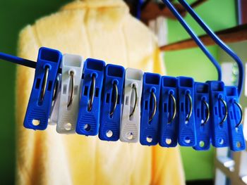 Close-up of clothespins hanging on clothesline