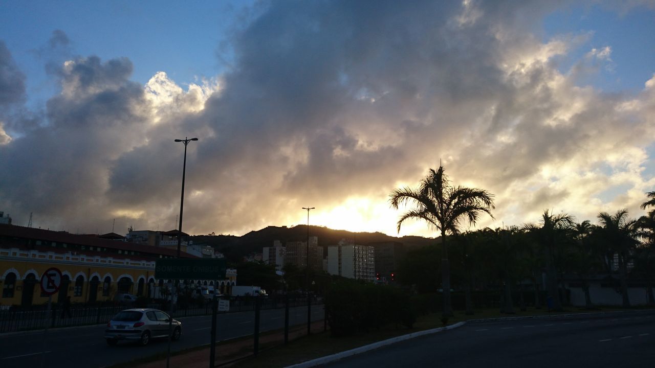 car, transportation, sky, sunset, no people, silhouette, cloud - sky, built structure, outdoors, road, tree, architecture, day