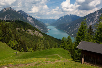 Scenic view of green landscape and mountains against sky
