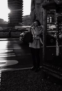 Woman standing on city street