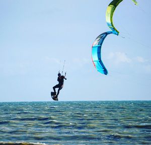 Man jumping in sea against clear sky