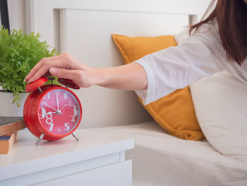 Midsection of woman with tattoo on table