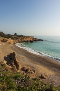 Scenic view of beach against clear sky