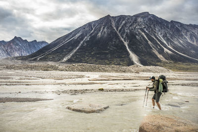 People on mountain against sky