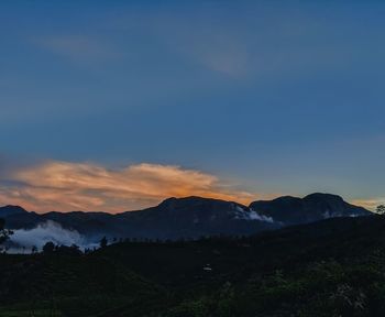 Scenic view of mountains against sky at sunset