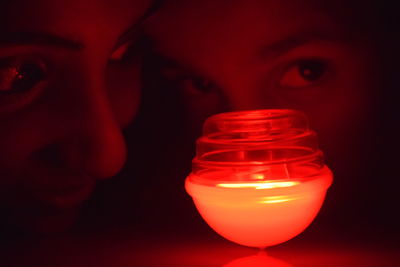 Close-up of illuminated lighting equipment against black background