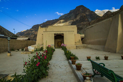 Entrance of temple by building against sky