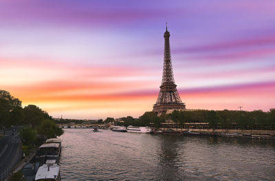 Tower in city at sunset