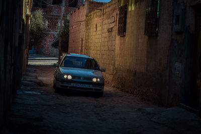 Car on street amidst buildings in city