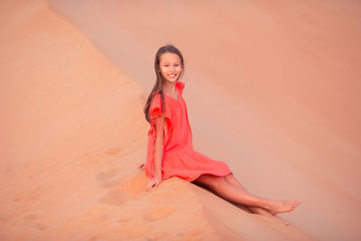 Portrait of girl sitting at desert